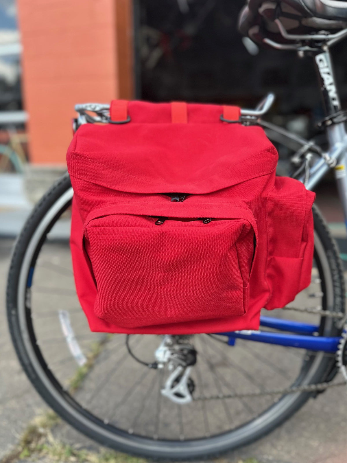 red saddle bag on the back of a bicycle, close up