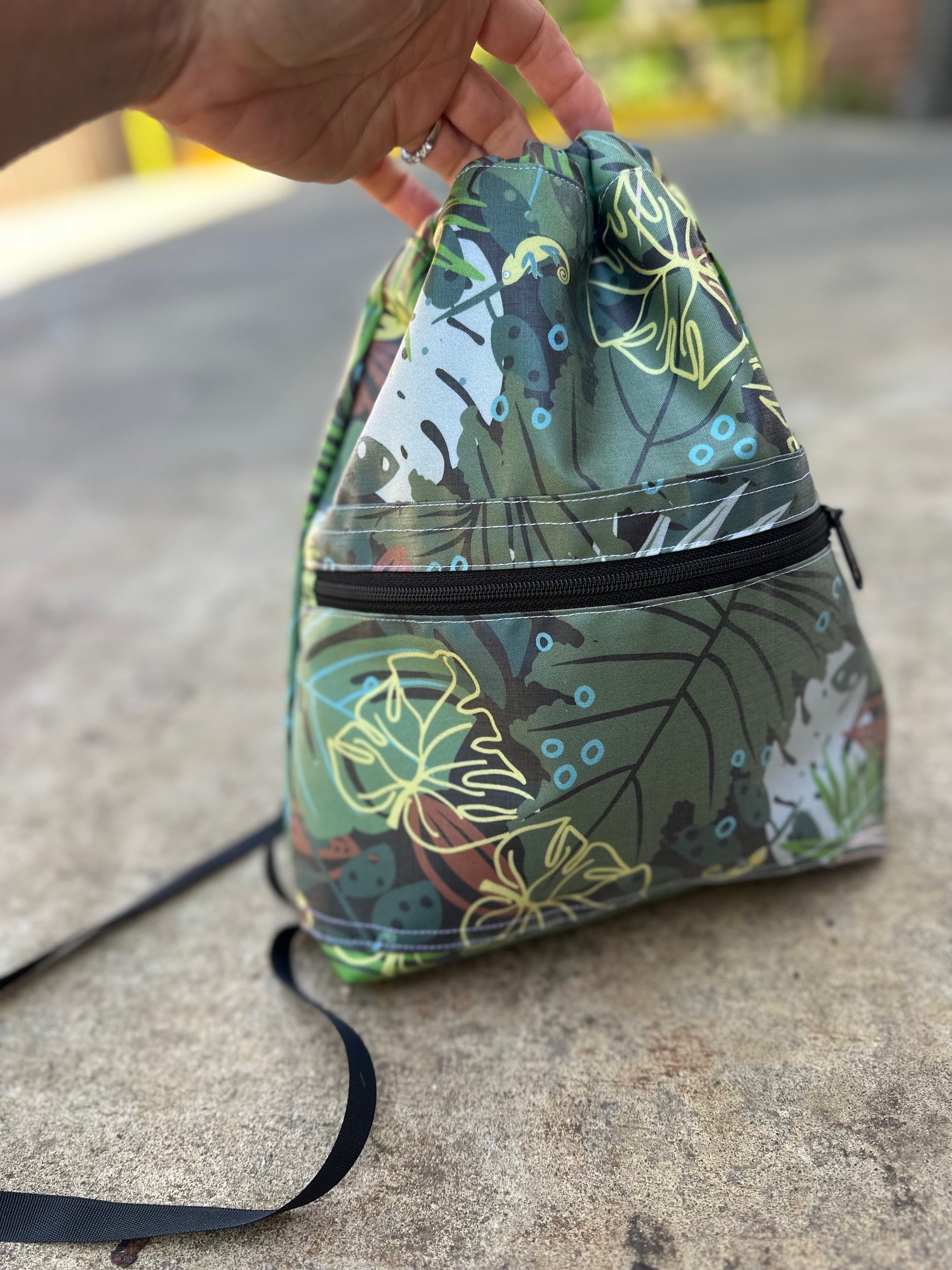 Drawstring bag with leaf pattern on a concrete surface