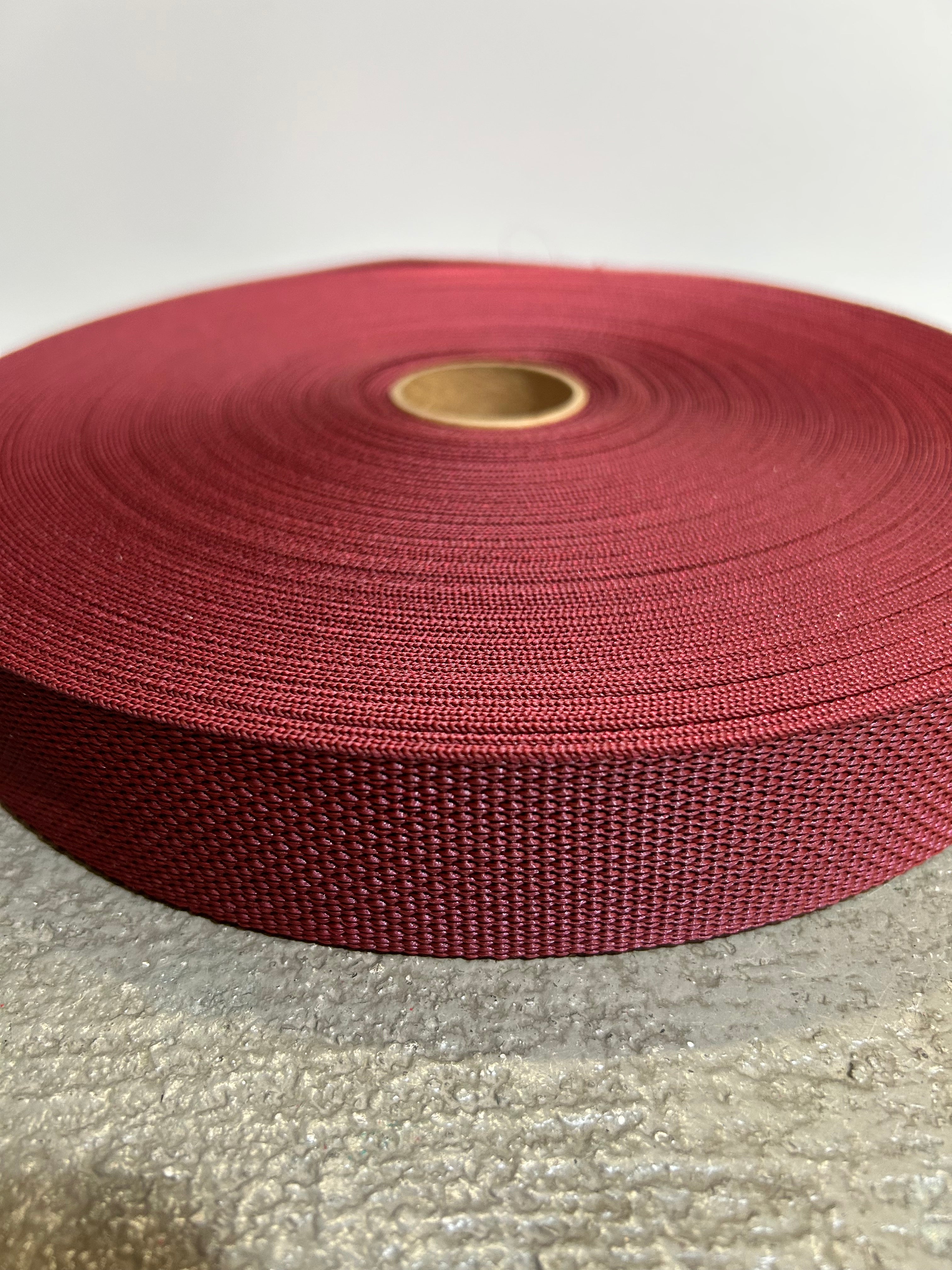 Marron webbing on a textured surface with a neutral background