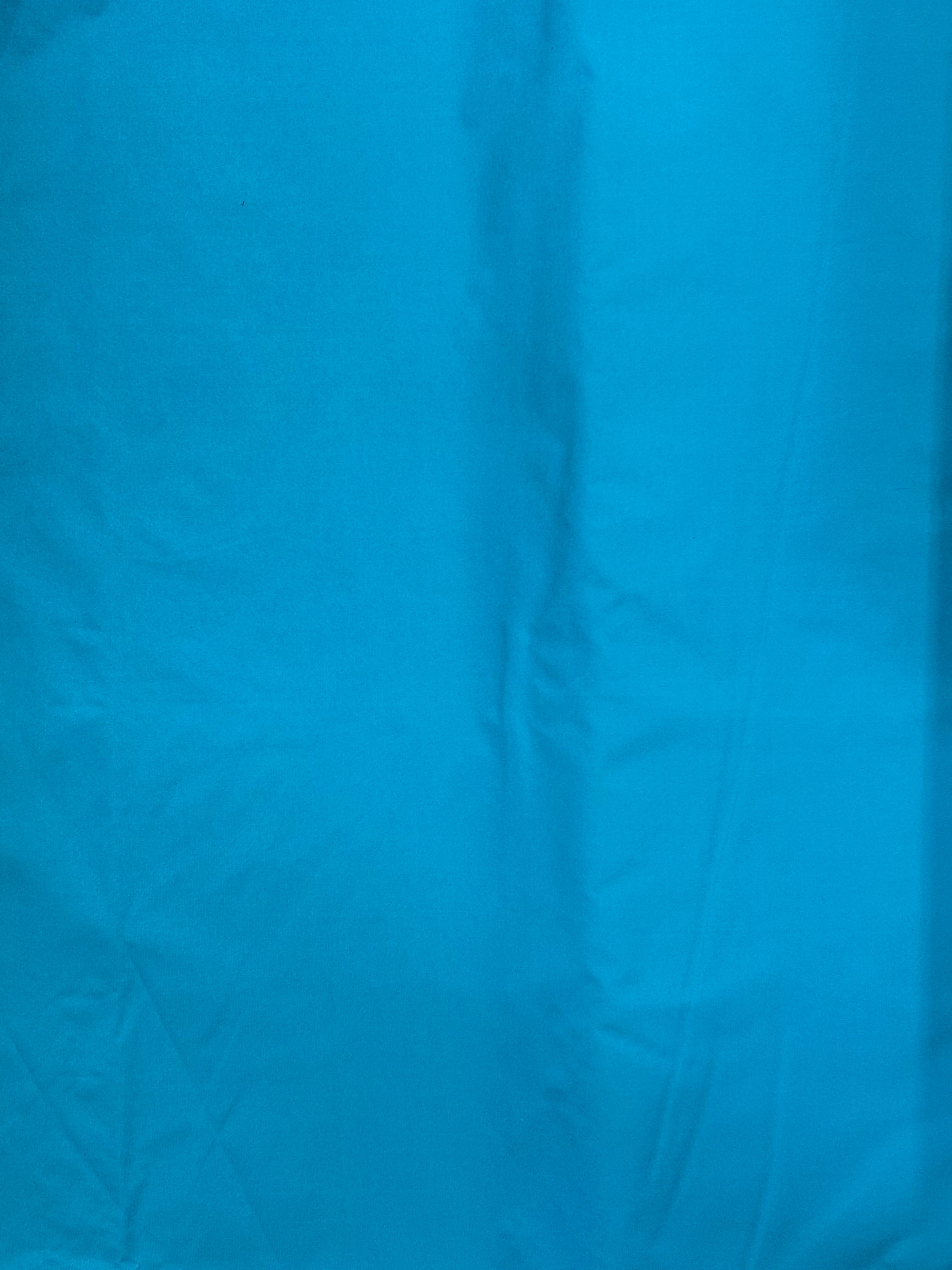 100% Nylon Tactel. Super quality with a DWR finish in a vibrant turquoise color