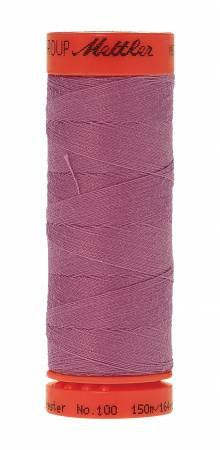 A spool of Mettler sewing thread in a dusty mauve-purple color, with orange-red plastic end caps, shown against a plain white background.