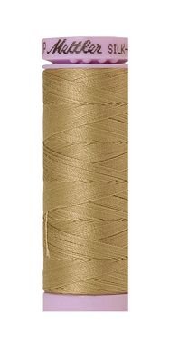 A spool of Mutler Silk thread in a light tan or beige color, with a pink cap and a pink bottom band, isolated on a white background.