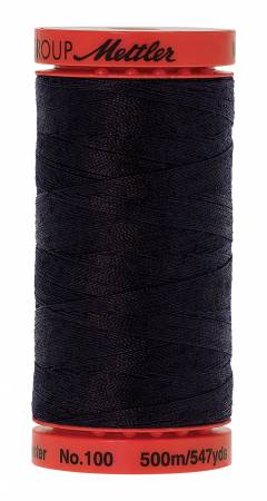 A spool of Mettler sewing thread, featuring dark navy blue thread wound around a red plastic core with a red top and bottom cap.