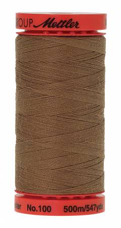 A spool of Mettler No.100 sewing thread in a warm brown color, with a red plastic top and bottom cap, isolated on a white background.