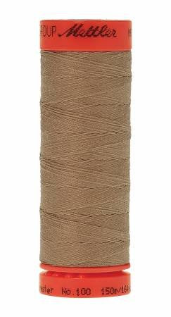 A spool of Mettler sewing thread in a warm taupe-brown color, featuring a bright orange-red top and bottom band with black text, isolated on a white background.