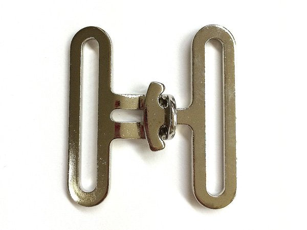 Metallic surcingle clasp on a white background