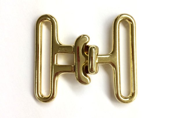 Gold metal surcingle on a white background