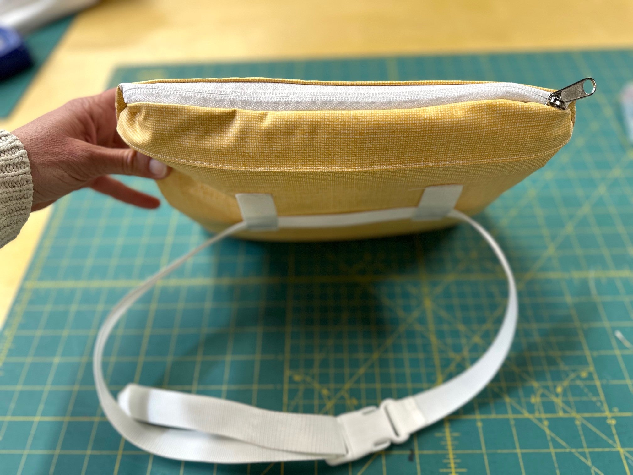 yellow poncho zippered pouch with a waist band.