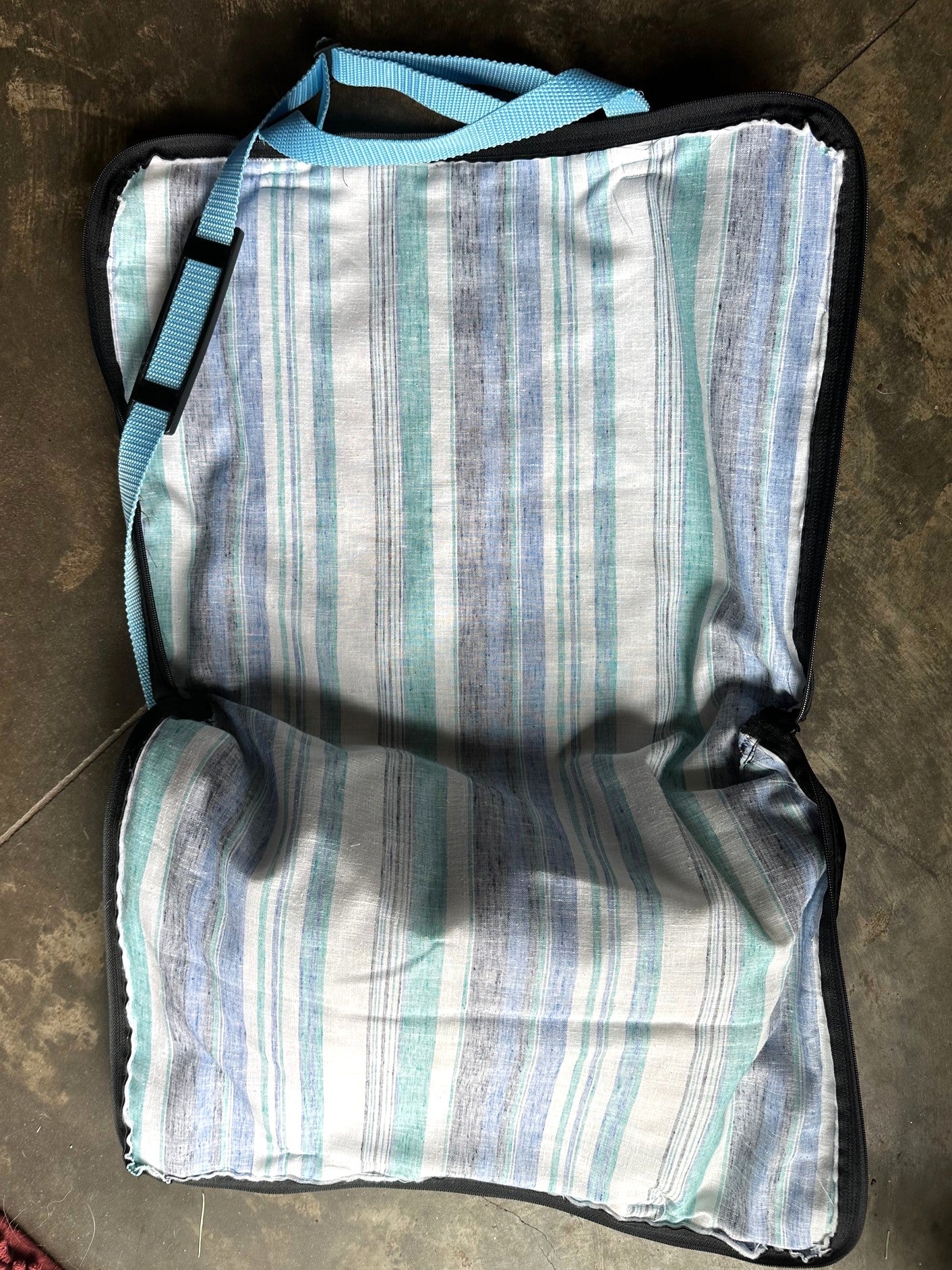 briefcase fully open to show blue striped inside.