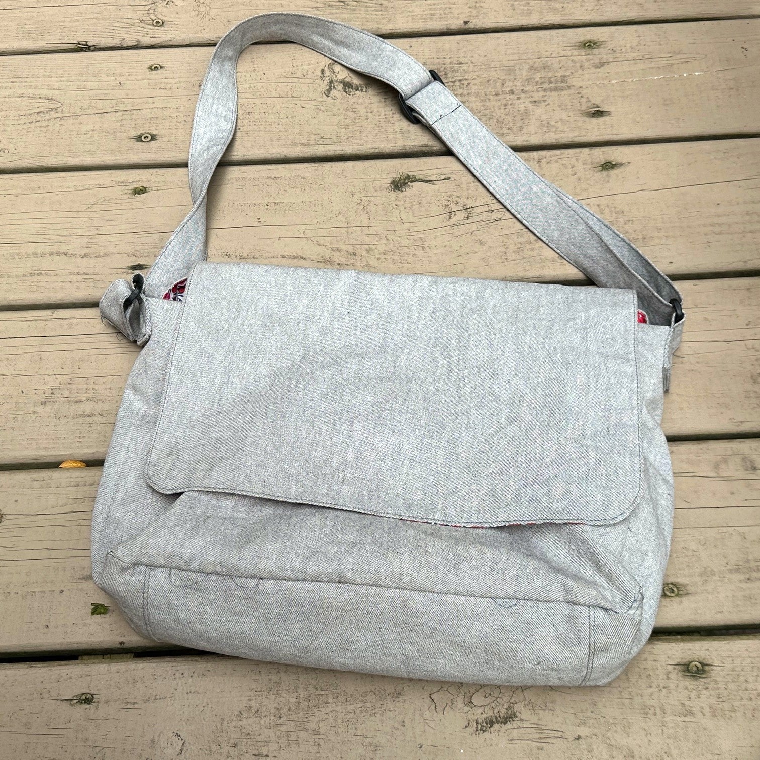 Gray shoulder bag on a wooden surface