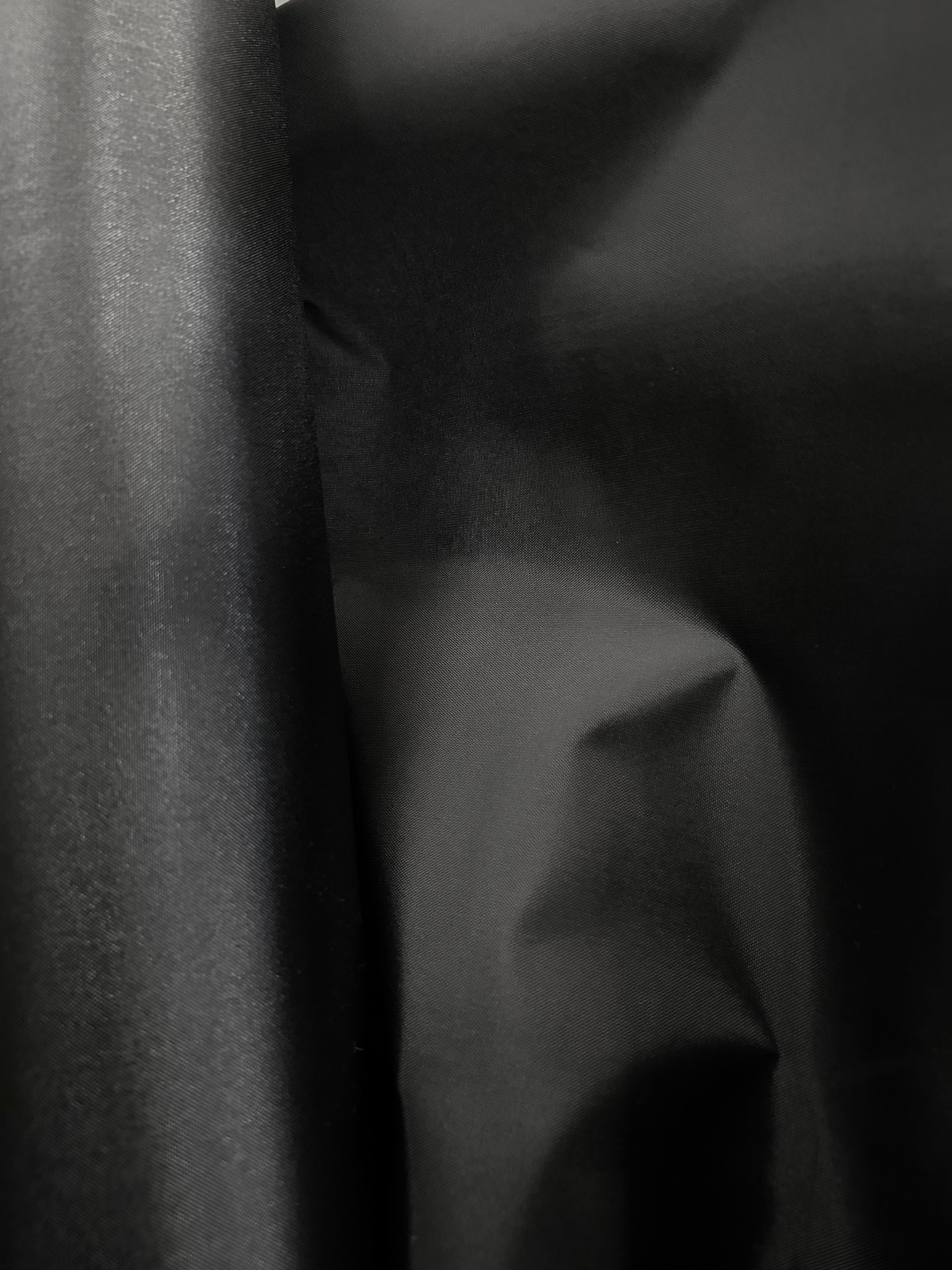 Coated black oxford cloth.