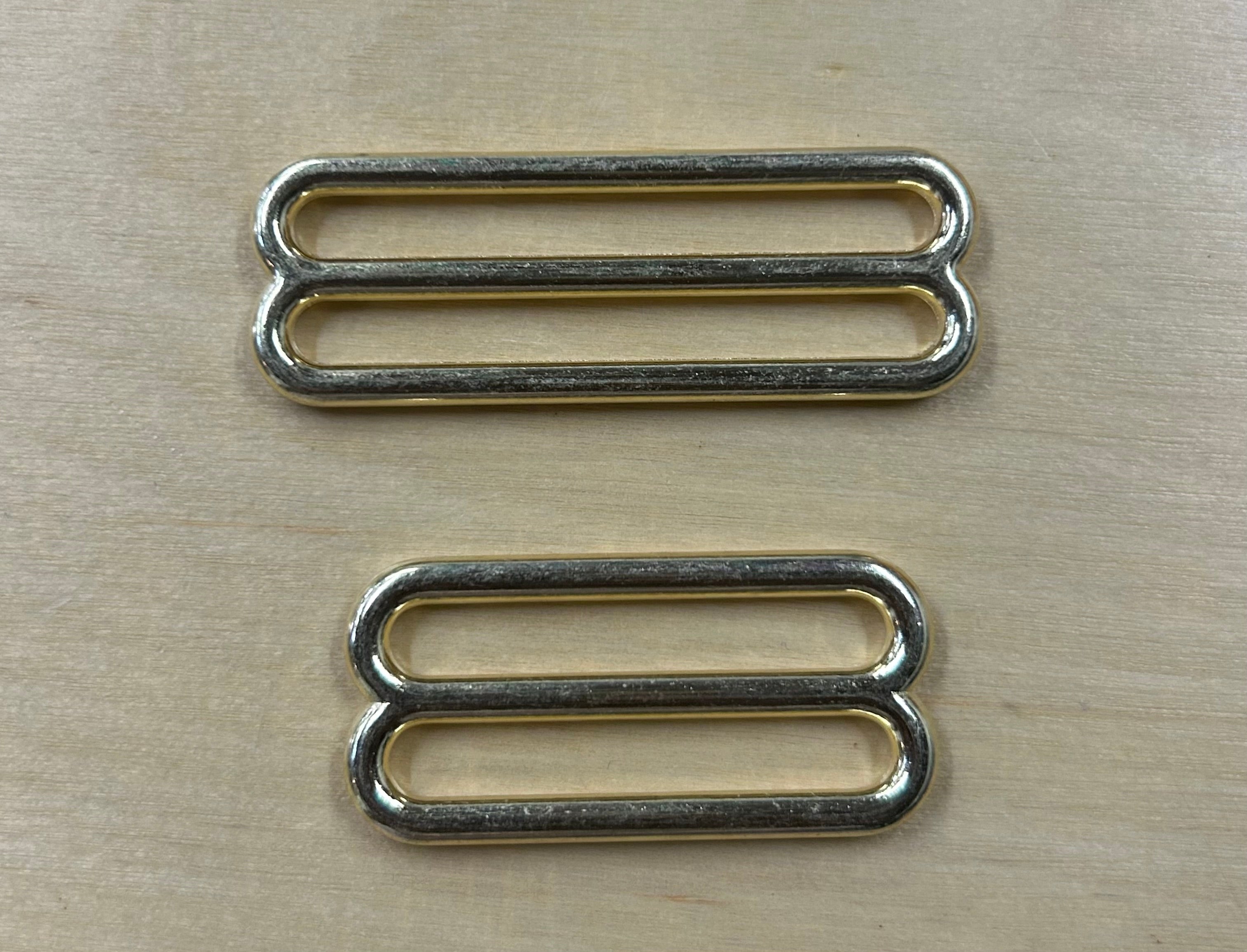 two bright brass sliders one 2 inch and on 1-1/2 inch