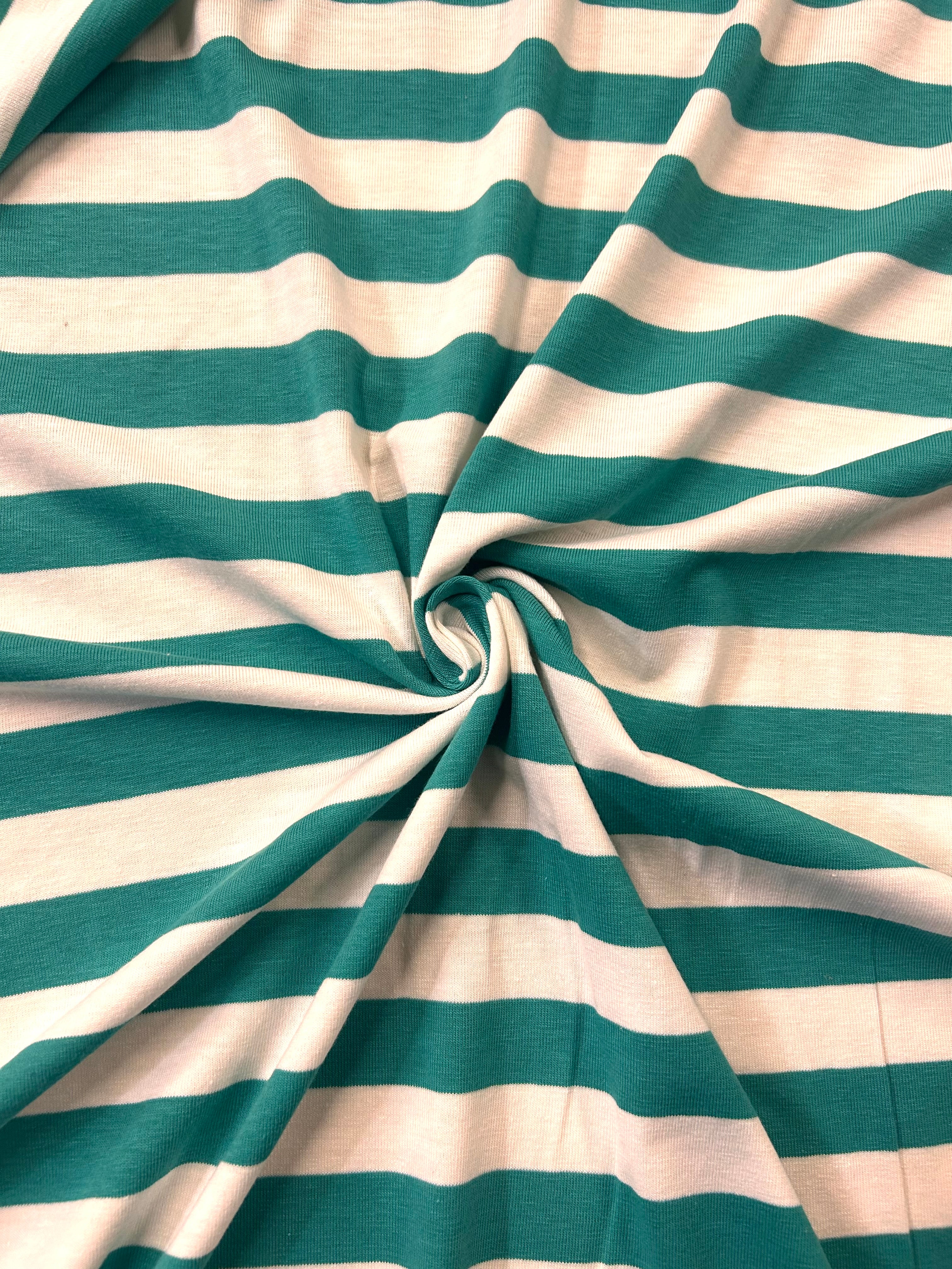 Teal and white striped fabric gathered in the center to show its drape and texture.