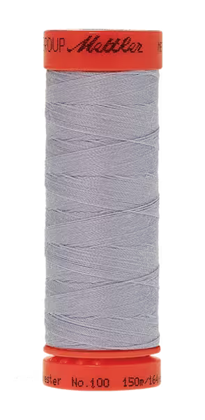 A spool of light gray sewing thread wound on a bright orange cone, shown against a plain white background. The brand name 'Mettler' is printed in black script on the orange top cap.