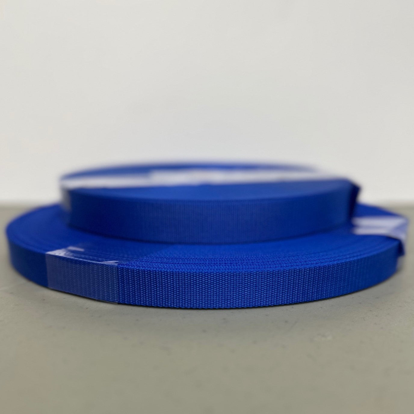 two rolls of blue nylon webbing