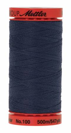 A spool of Mettler No.100 sewing thread in a dark slate blue color, with red plastic end caps and black printed branding.