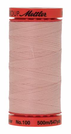 A spool of light pink sewing thread with red end caps, branded metterl No. 100, on a plain white background.