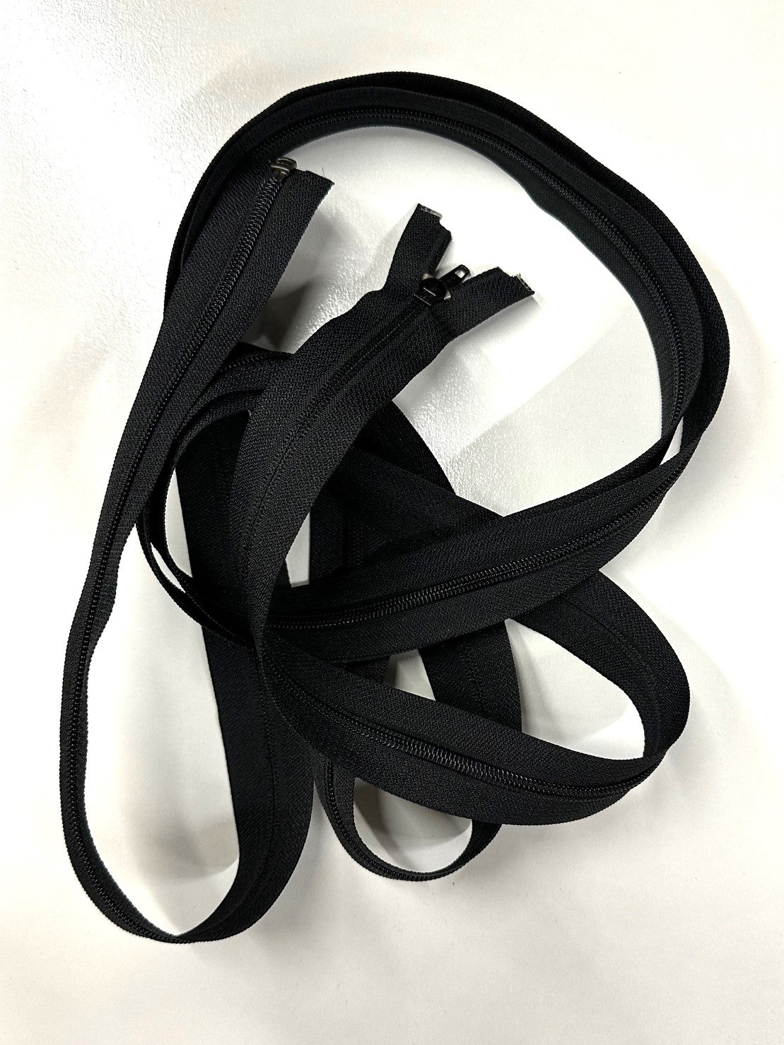 black coil zipper in a pile