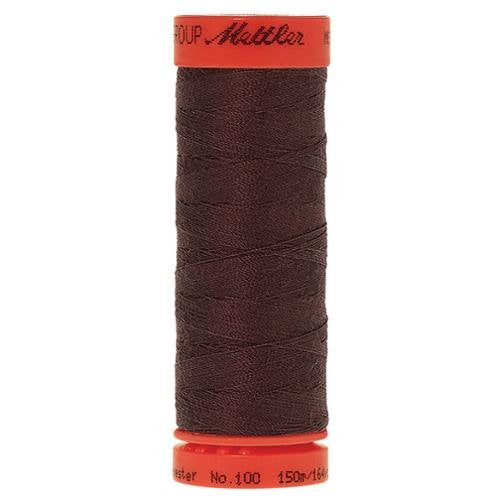 A spool of dark brown sewing thread with orange-red plastic end caps, showing the brand name 'Mettler' on the top cap.