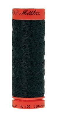 Spool of dark green thread with red label on a white background
