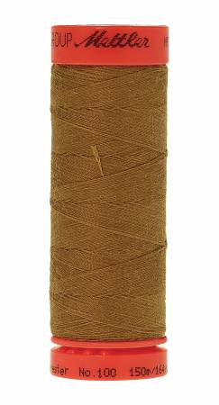 A spool of Mettler sewing thread in a warm brown color, featuring a red-orange top and bottom cap with black branding text, isolated on a white background.