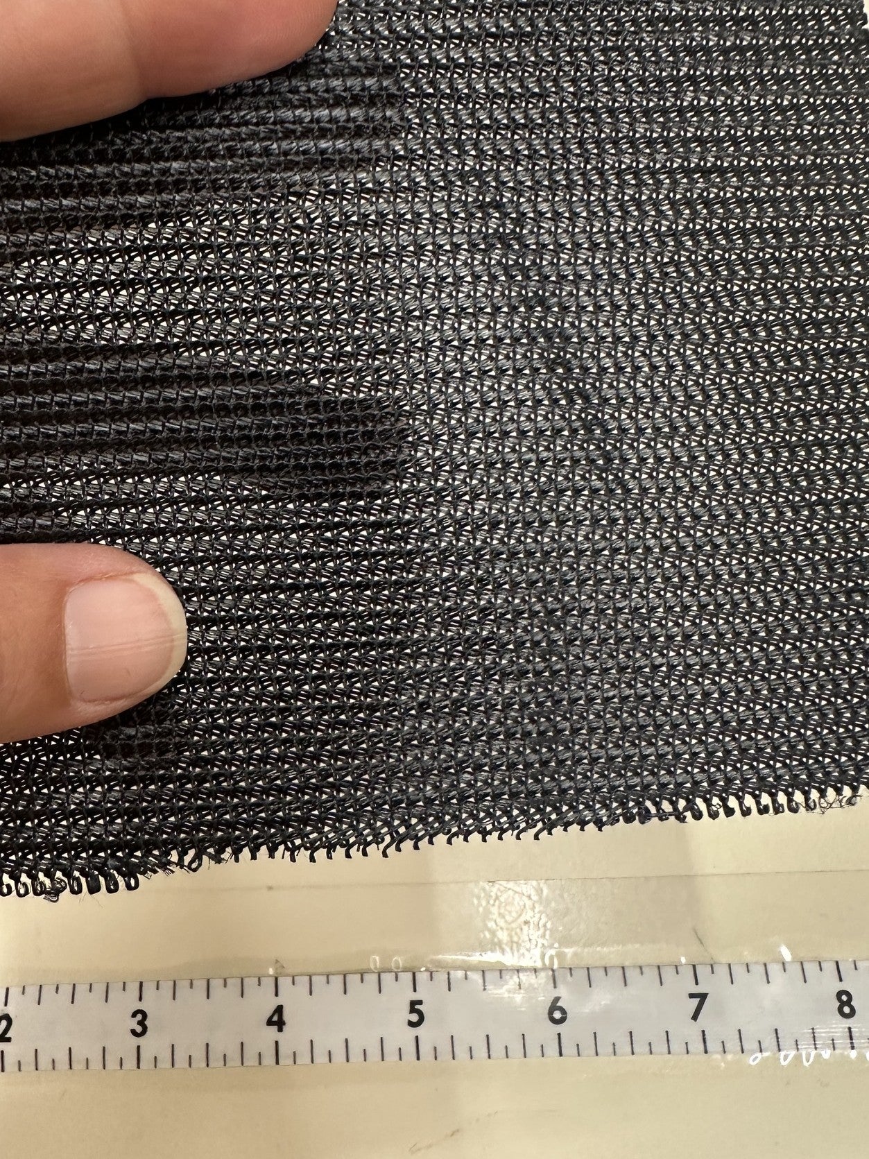 Close up of leno lock mesh fabric with a ruler below