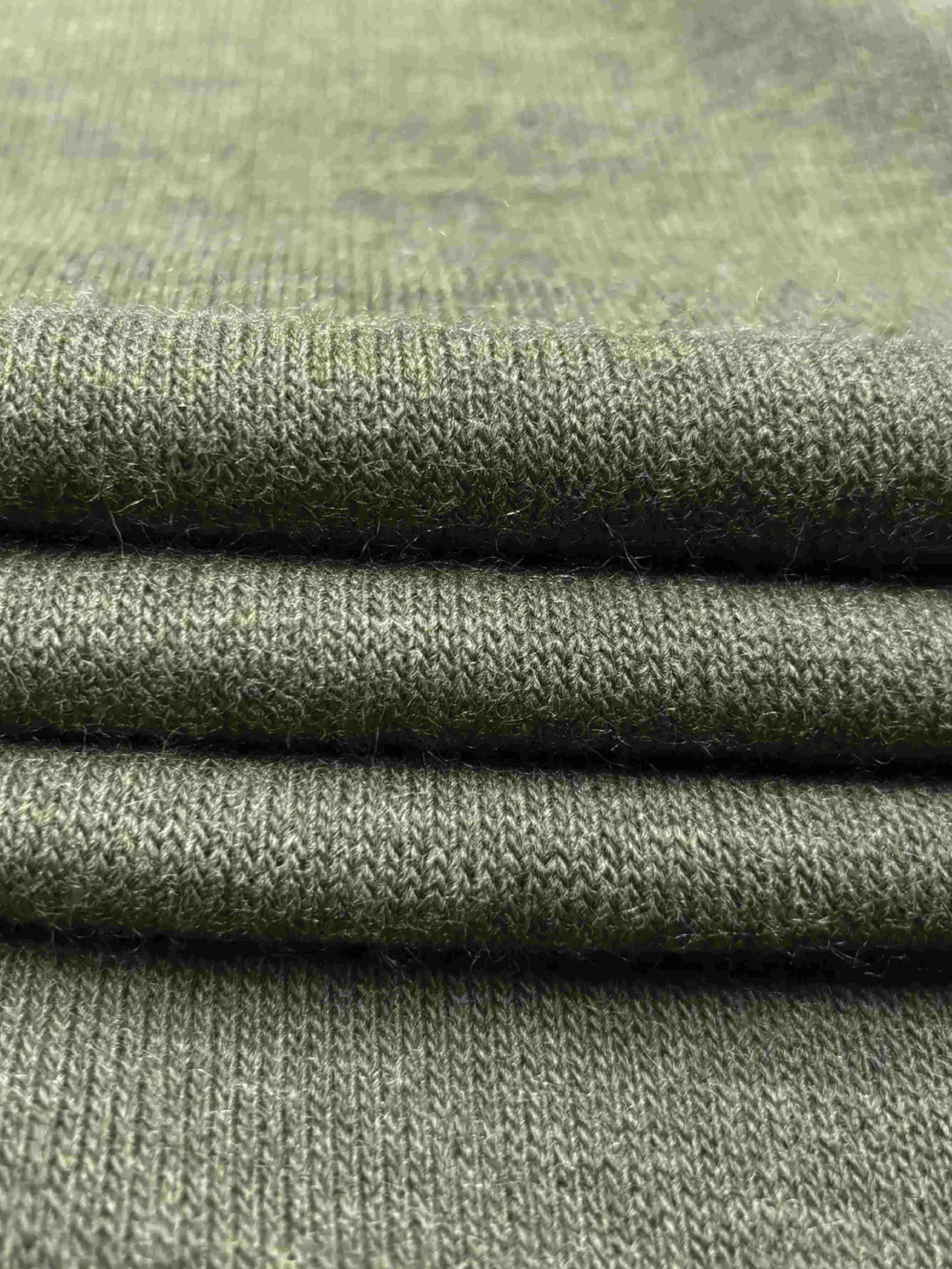 Close-up of folded knit green fabric 