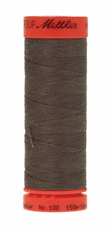 A spool of Mettler sewing thread, featuring dark brown thread wound around a spool with a red-orange top and bottom cap. The brand 'Mettler' is printed in black on the top cap.