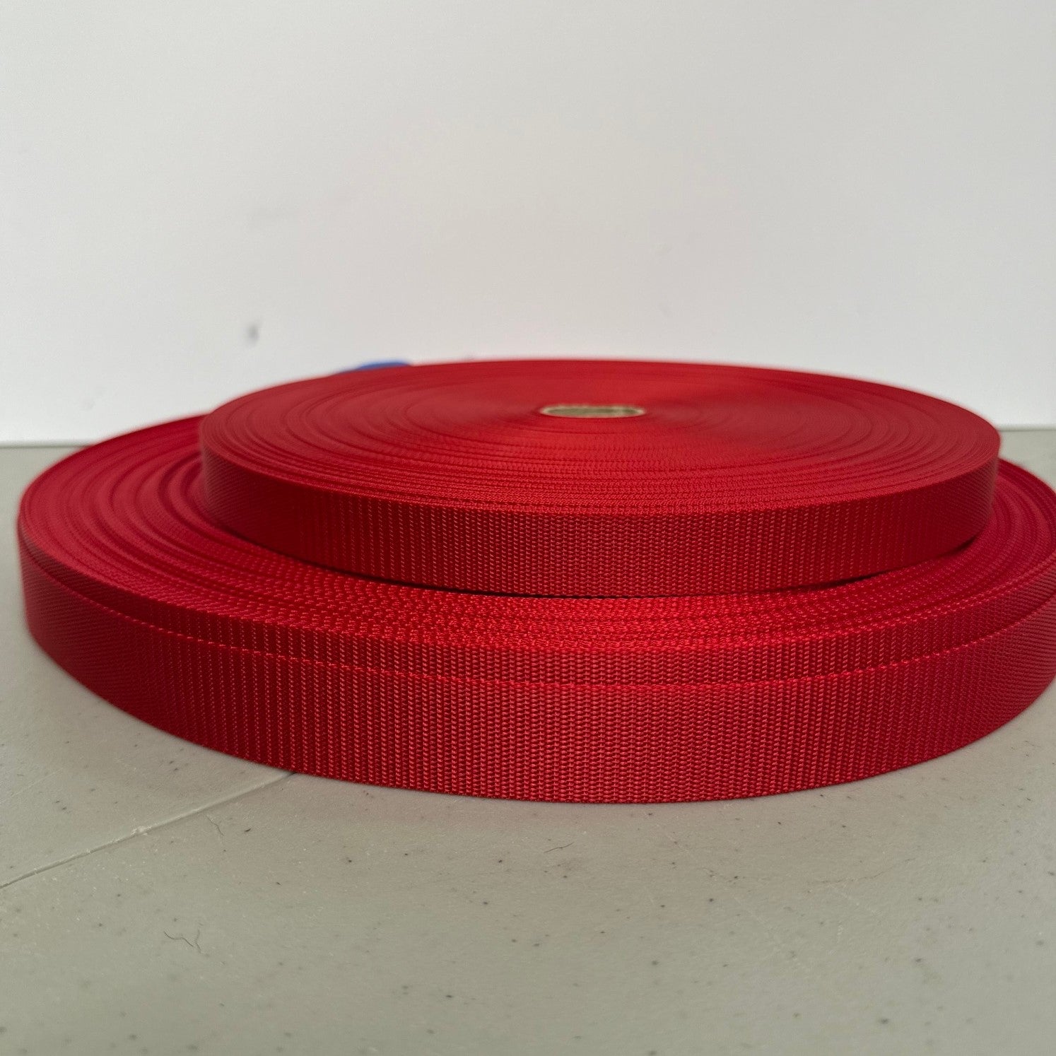 two rolls of red nylon webbing