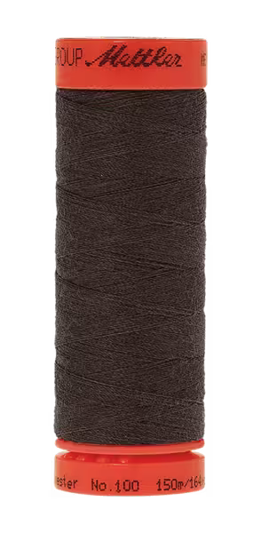 A spool of dark brown sewing thread wound on a red spool, with the brand name 'Mettler' visible on the top and bottom red ends, isolated on a white background.